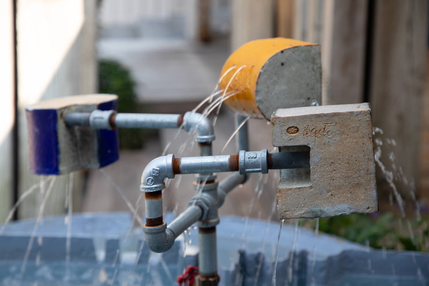 Close up of glazed ceramic fountainheads at the Moore/Andersson Compound in Austin, Texas