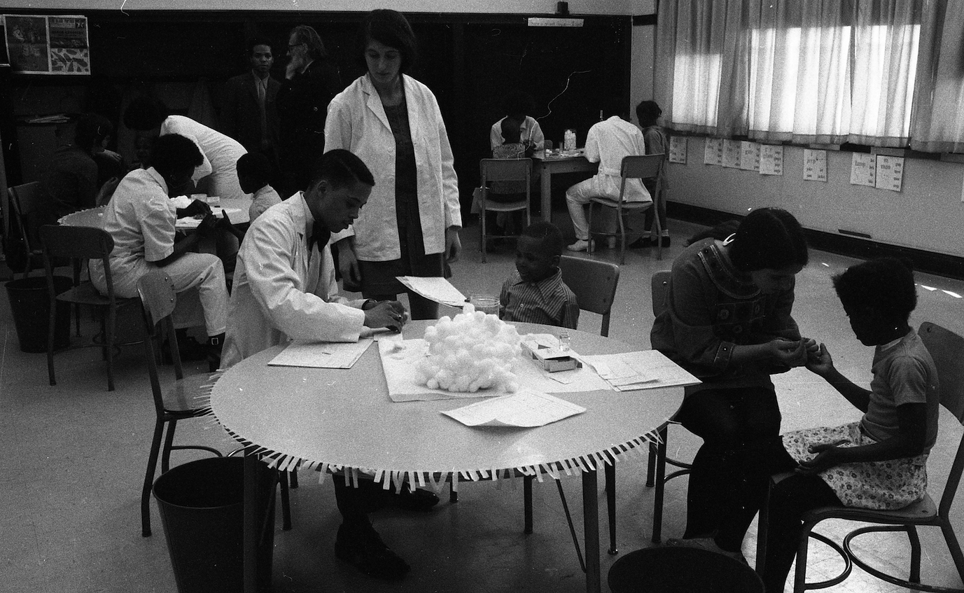 Black and white image of children undergoing sickle cell anemia testing at William Penn Elementary, in 1971