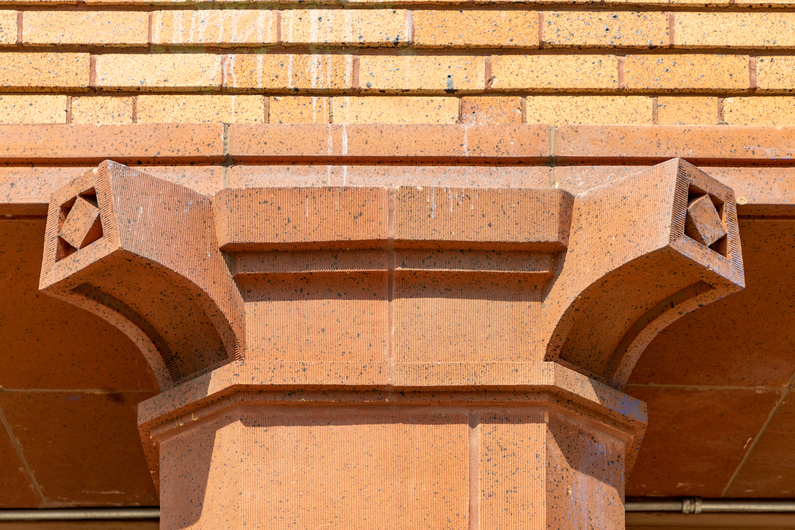 Close up detail shot of the top of a column at Chicago’s Carl Schurz High School.